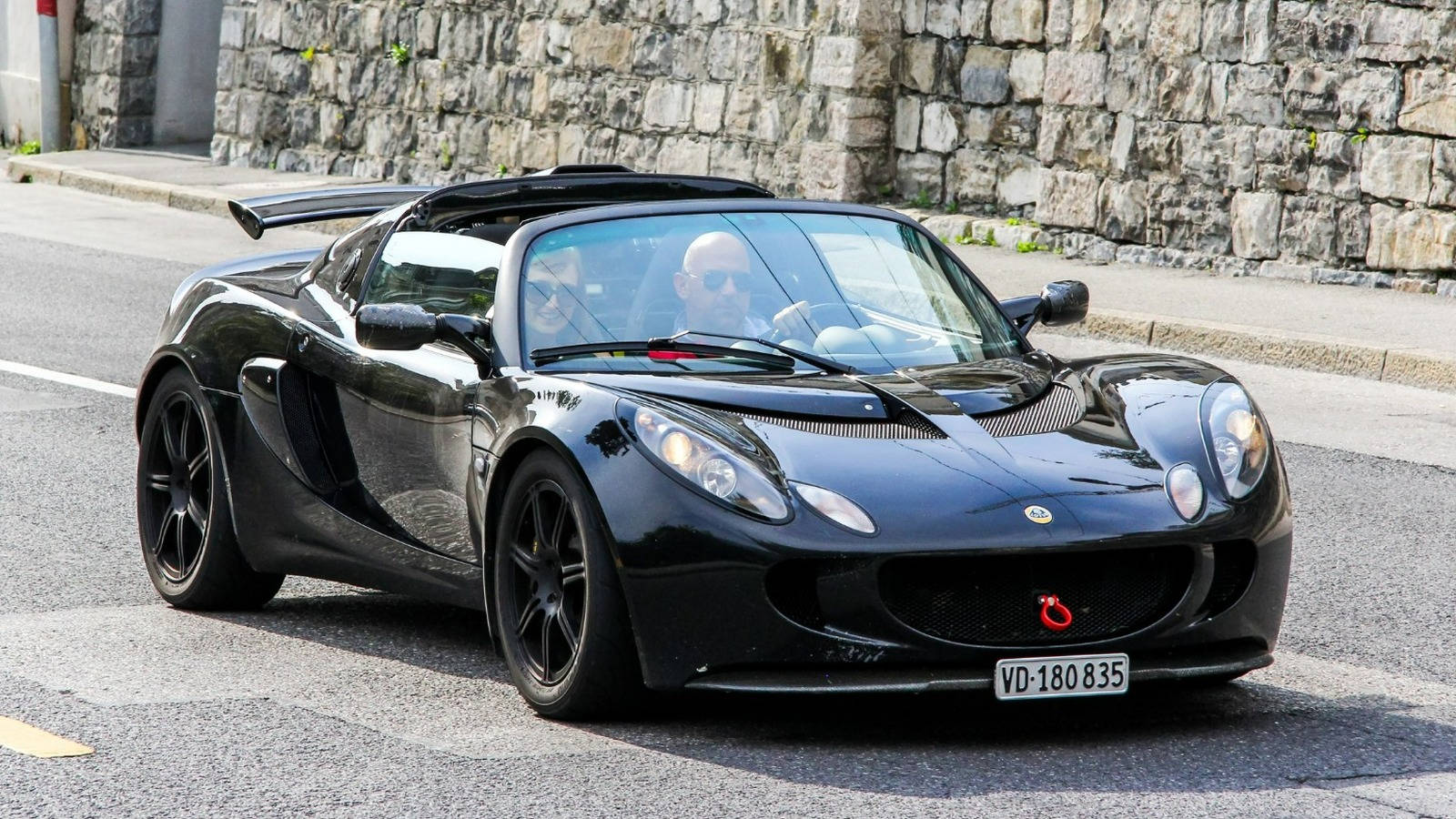 Lotus Elise Sport Car On The Road Background