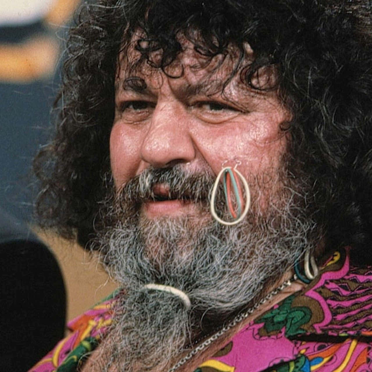 Lou Albano With Rubber Bands On His Cheek Background