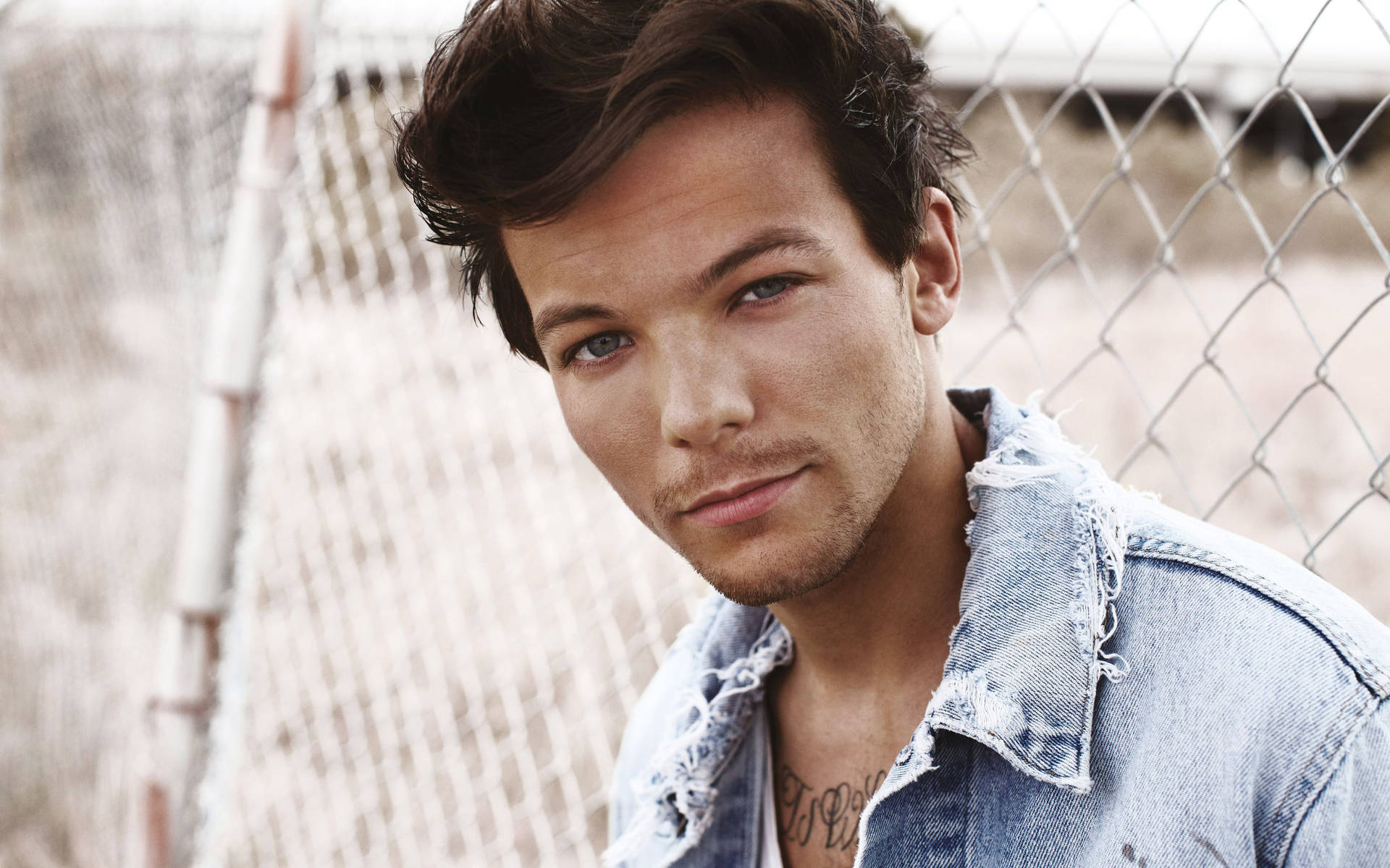 Louis Tomlinson Looking Stylish In A Jean Jacket Background