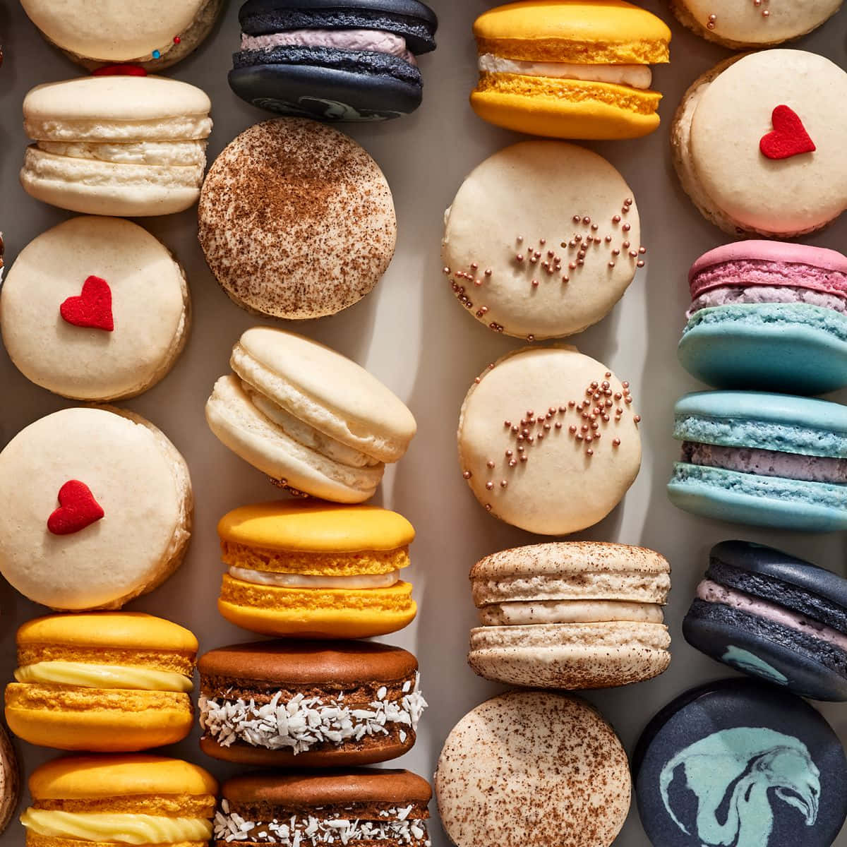 Love For French Macarons: Colourful Dessert Arranged In A Heart Shape Background