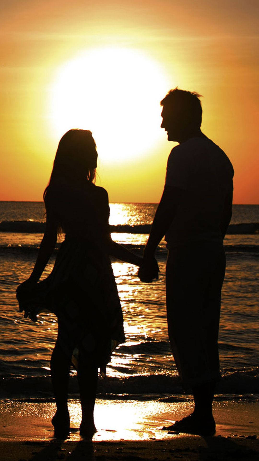 Love In Paradise: Couple Enjoying A Tranquil Beach Moment