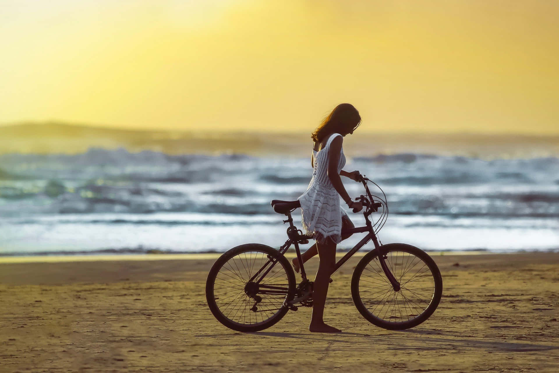 Lovely Girl On Beach Riding Bicycle