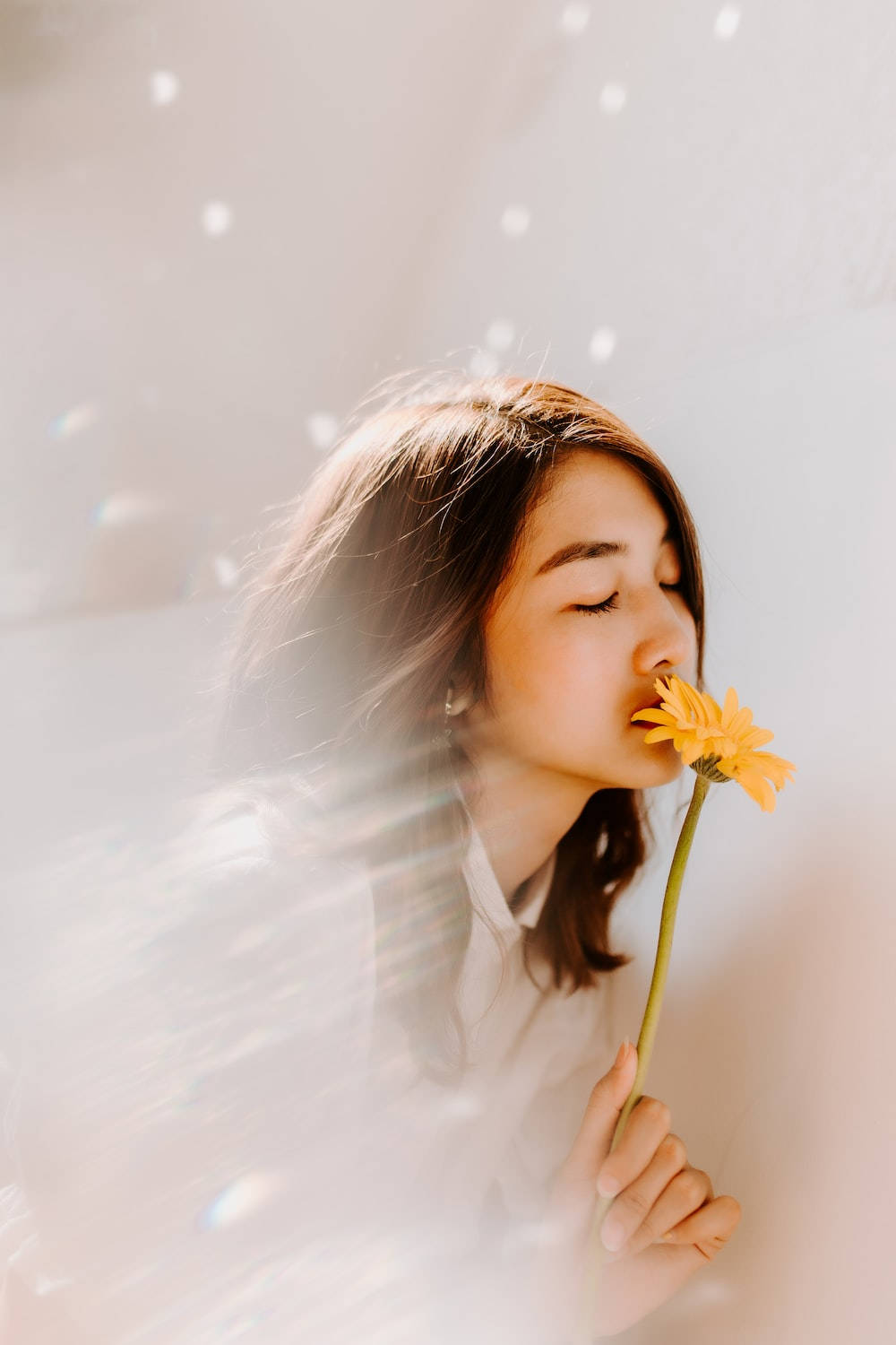 Lovely Girl Sniffing A Yellow Flower