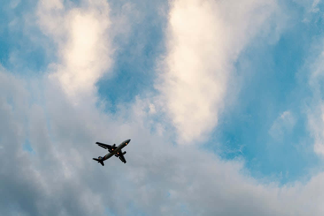 Low Angle Of Distant Small Airplane Background