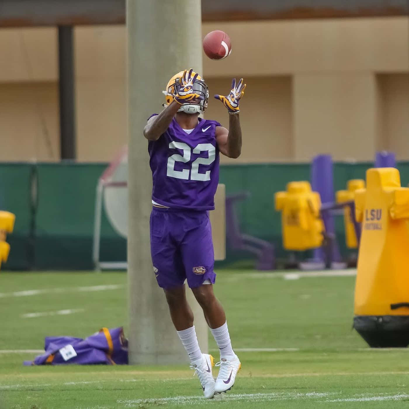 Lsu Football Player Catching A Ball In The Air Background