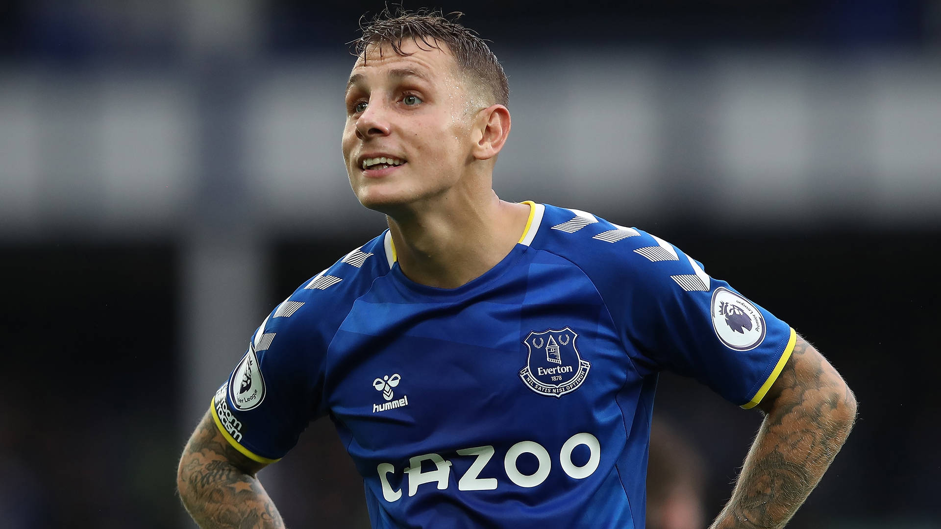 Lucas Digne Smiling On The Field Background