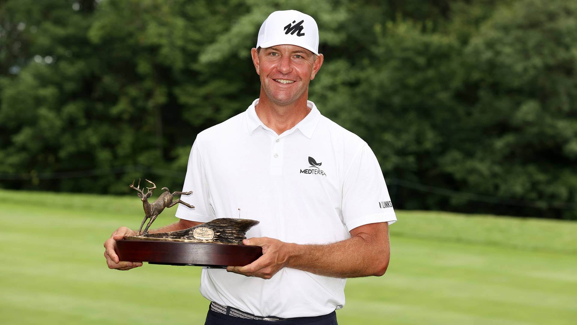 Lucas Glover Celebrating His Victory With A Trophy Background