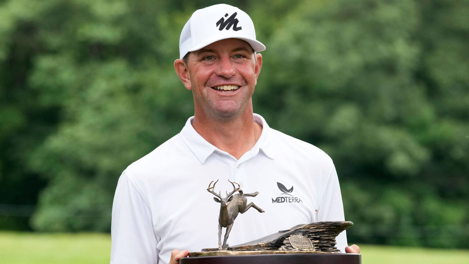 Lucas Glover Triumphantly Displaying Championship Trophy Background