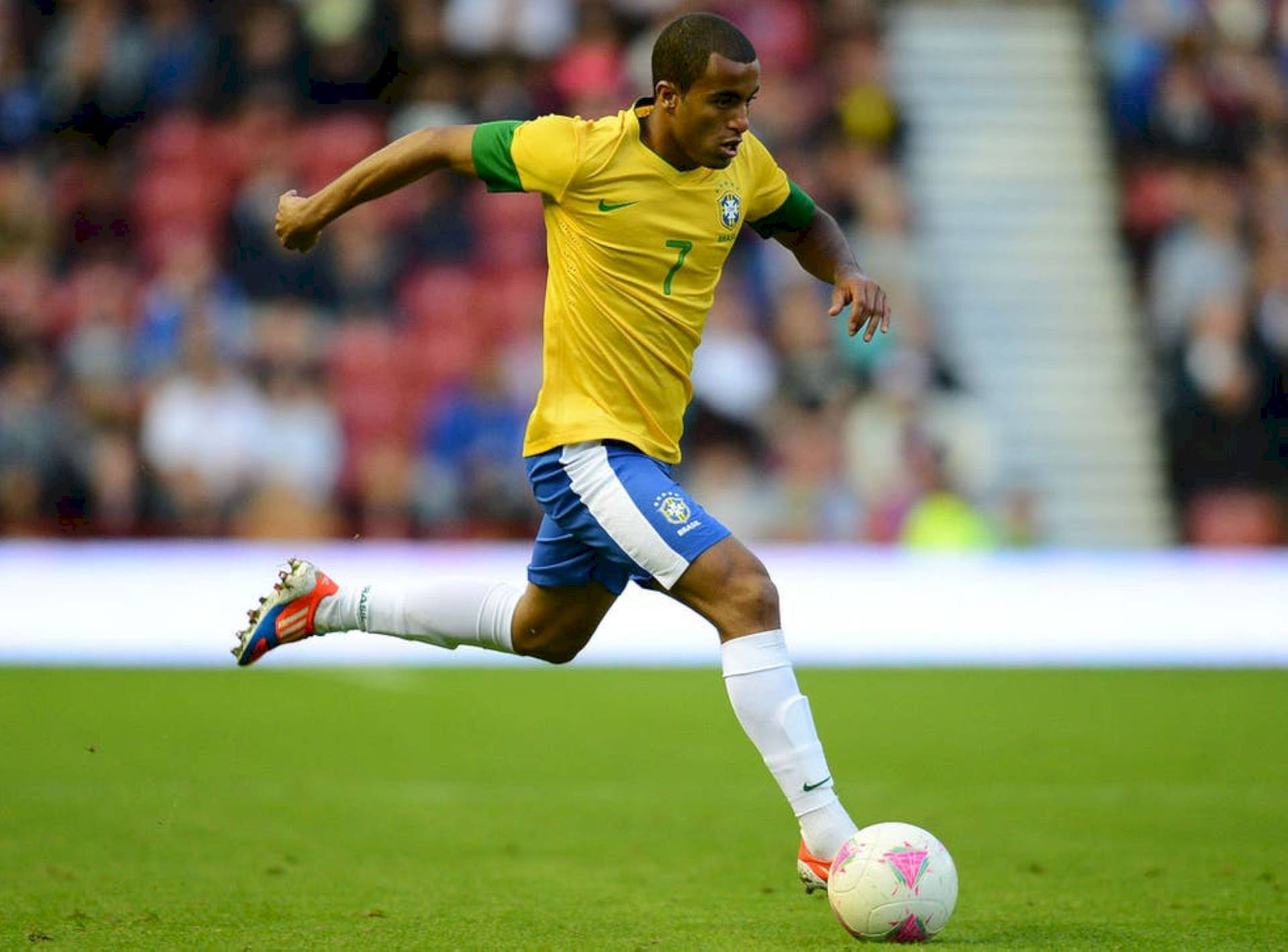 Lucas Moura Kicking Football On Field Background