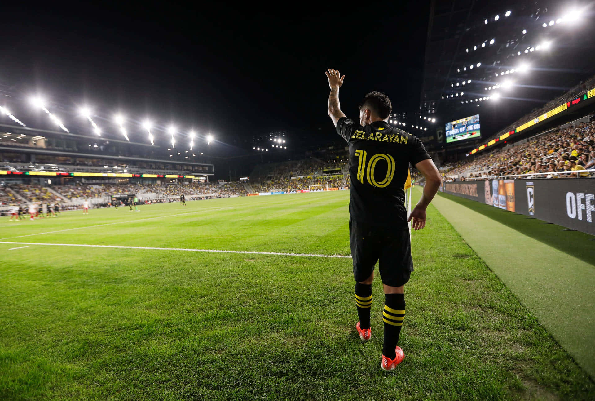 Lucas Zelarayan On A Massive Football Field Background