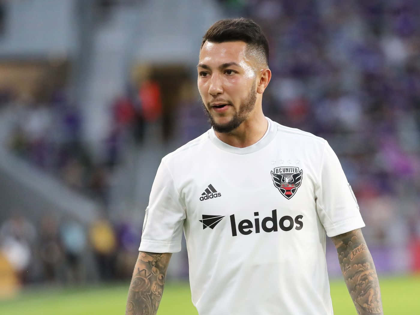 Luciano Acosta In His White Leidos Football Jersey Background