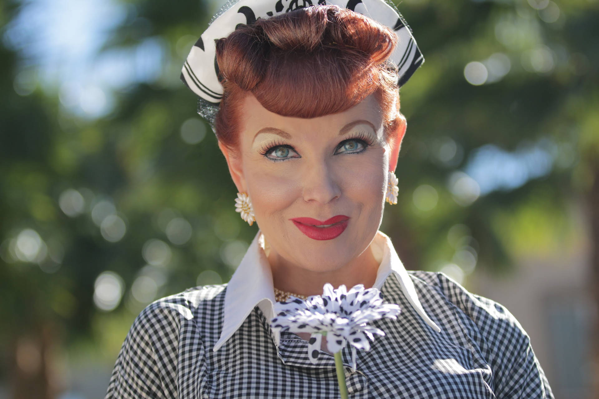 Lucille Ball Holding A Flower Background