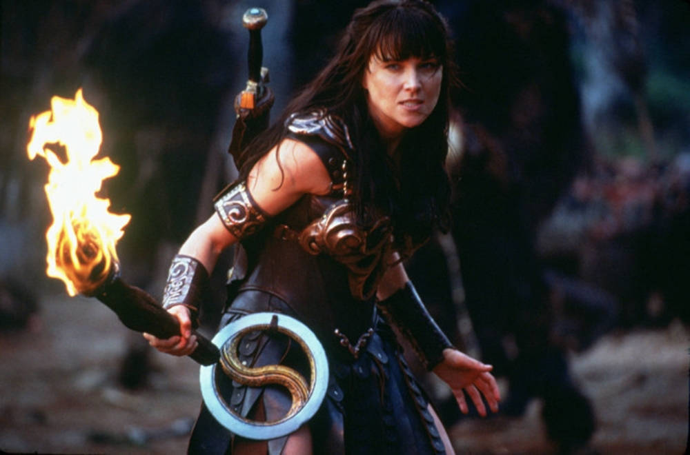 Lucy Lawless With Burning Torch Background