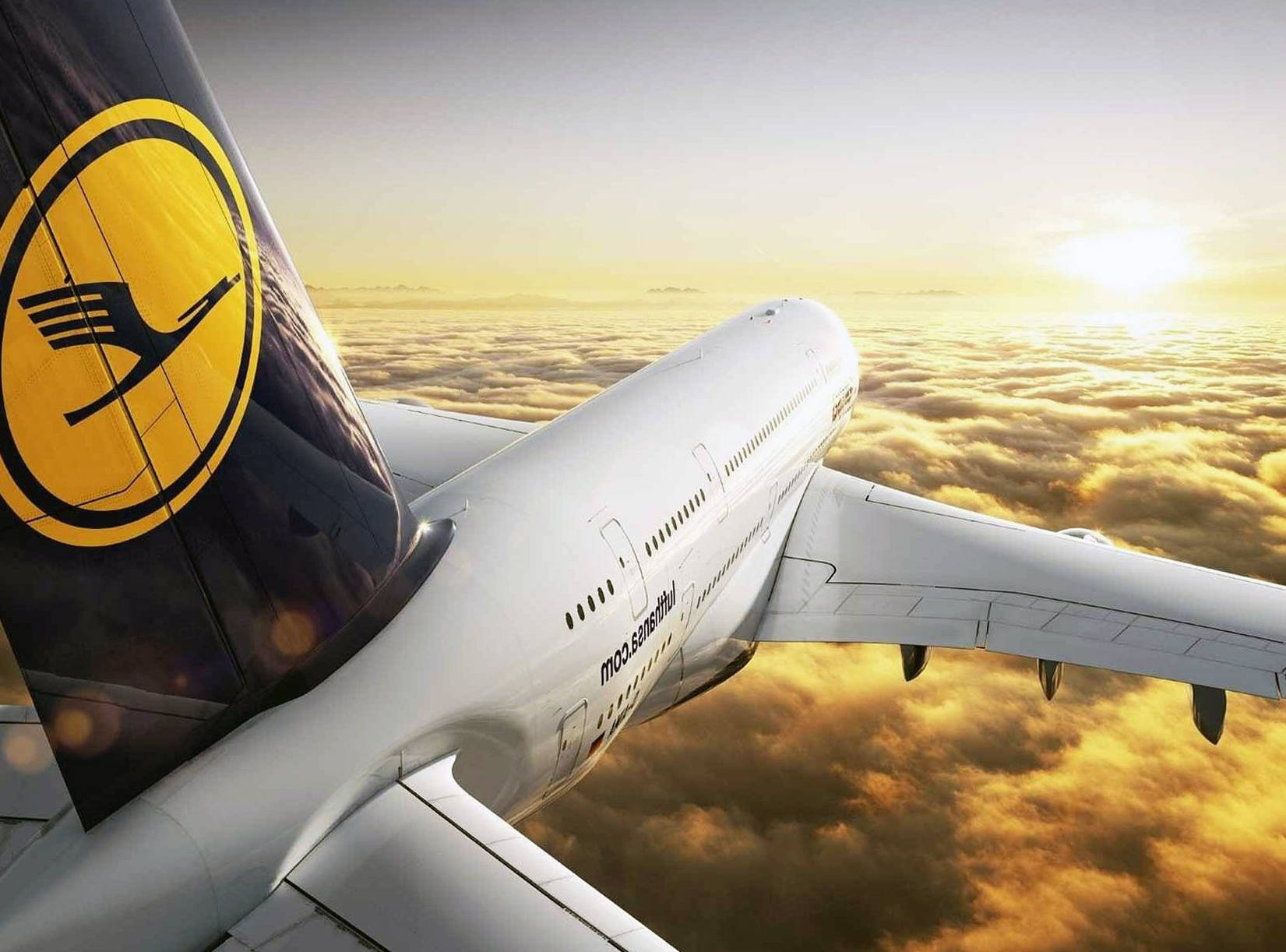 Lufthansa Plane Flying Over Golden Clouds Background