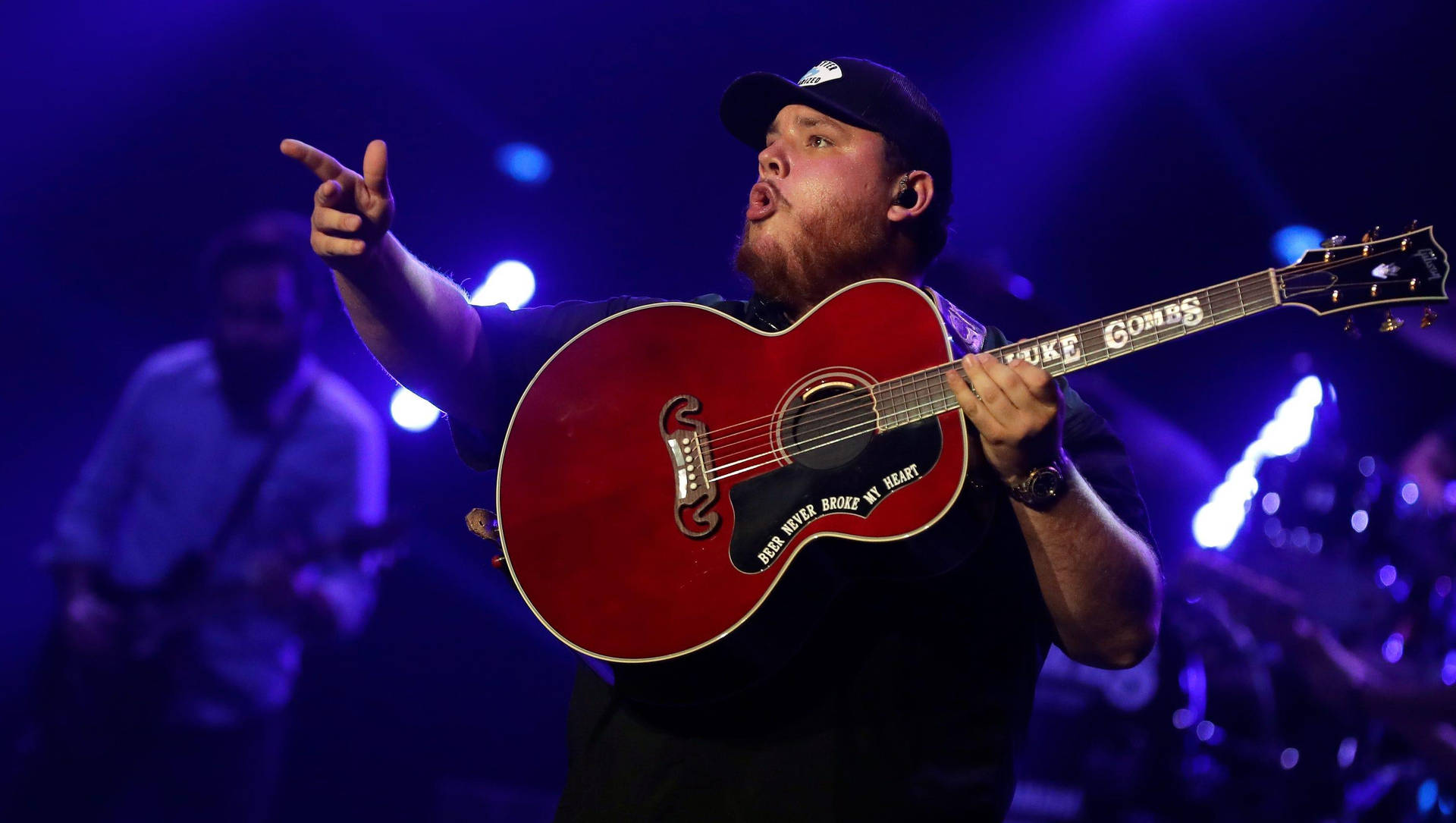 Luke Combs Performing In Concert Background