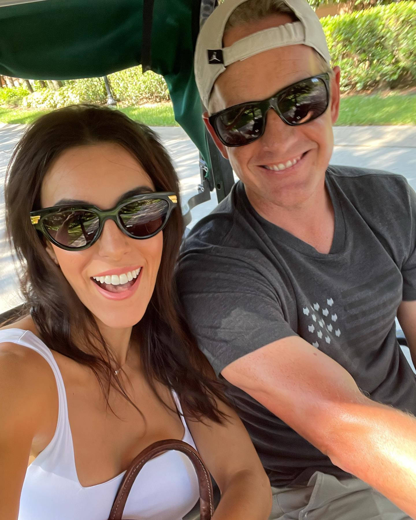 Luke Donald And Wife Riding Cart Background