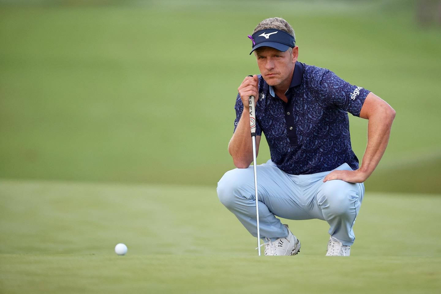 Luke Donald Intense Focus On Golf Ball Background