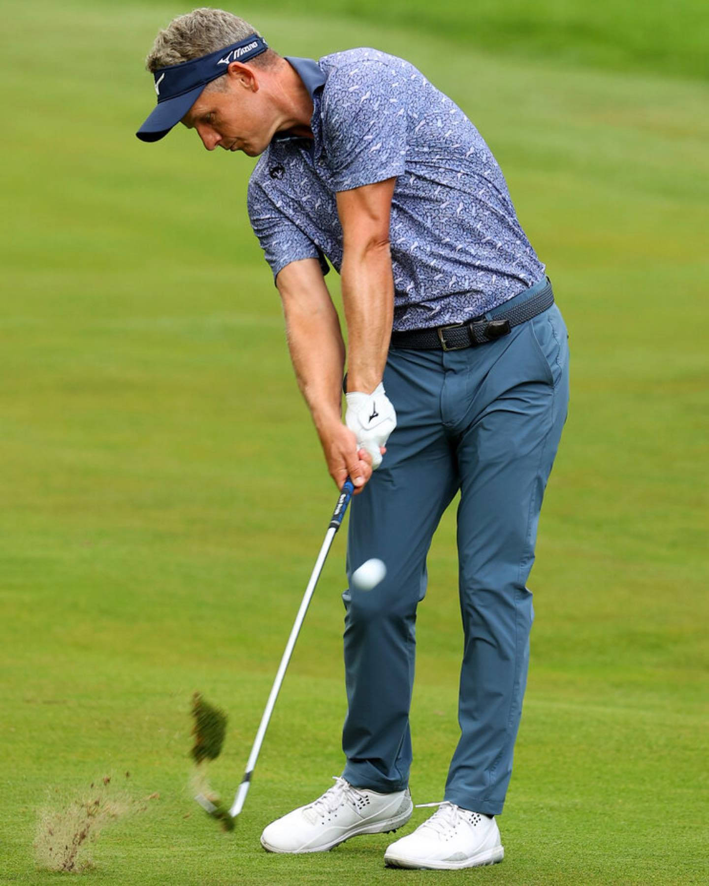 Luke Donald Posture While Hitting Ball Background