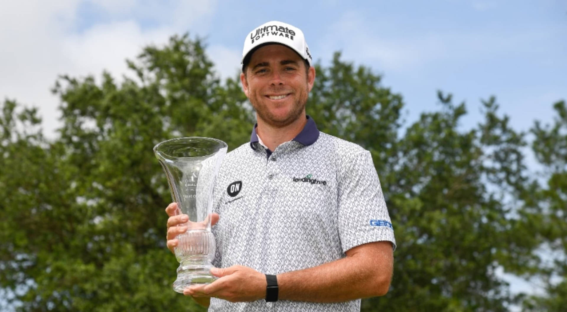 Luke List Holding Glass Trophy Background