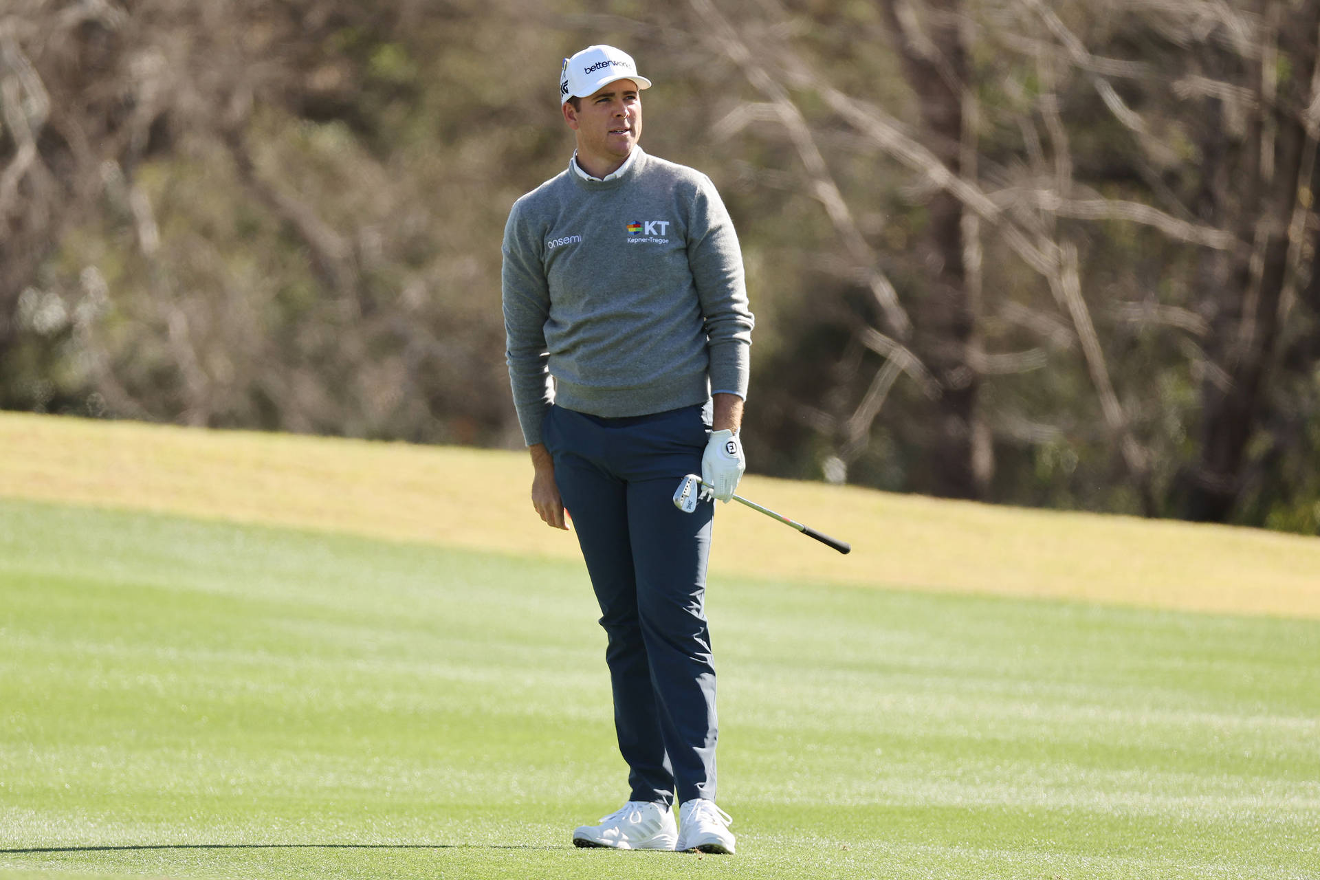 Luke List Standing On Golf Course Background