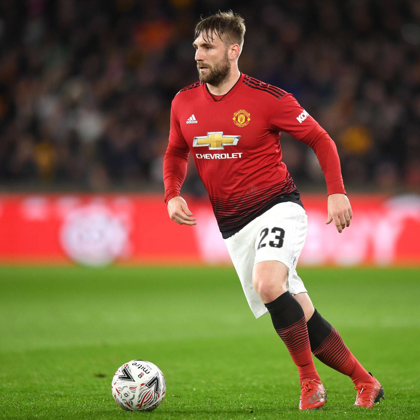 Luke Shaw Running With Football Background