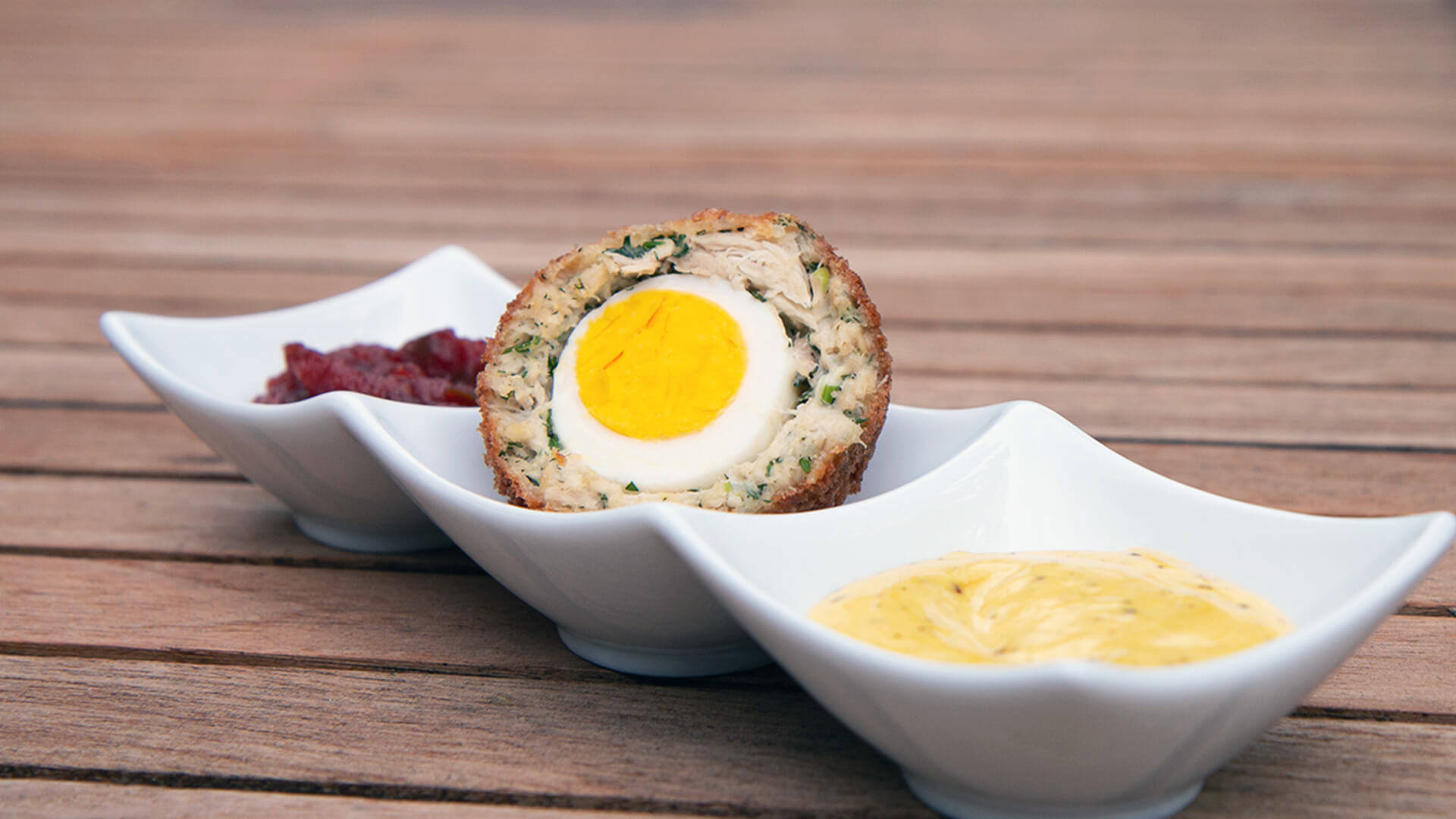 Luscious Scotch Egg British Dish With Mustard Sauce Background