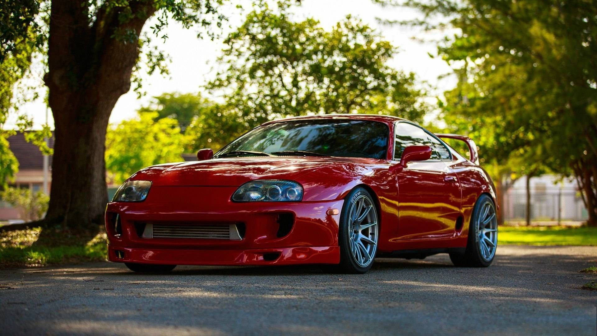 Lustrous Red Toyota Supra Car Background
