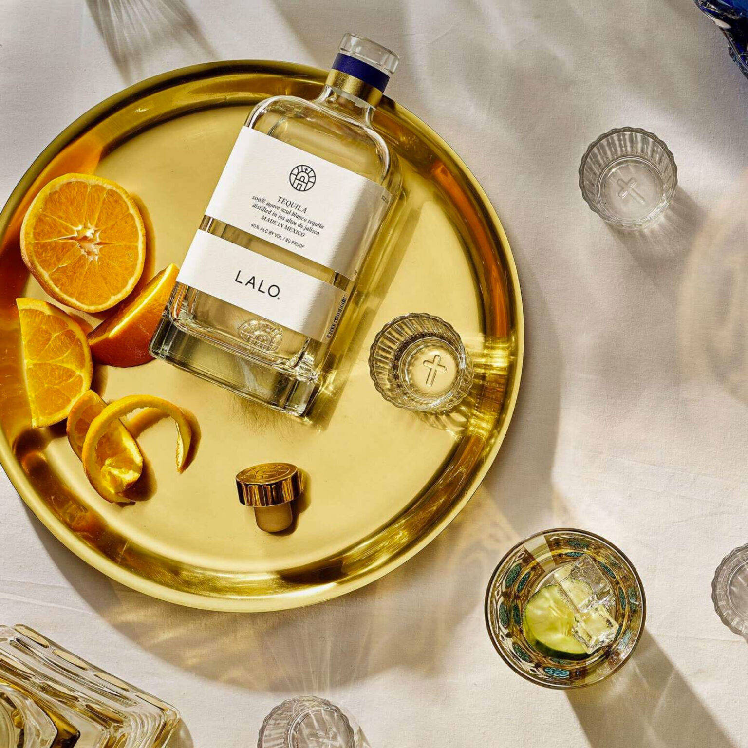 Luxurious Lalo Tequila Served On A Golden Plate Background