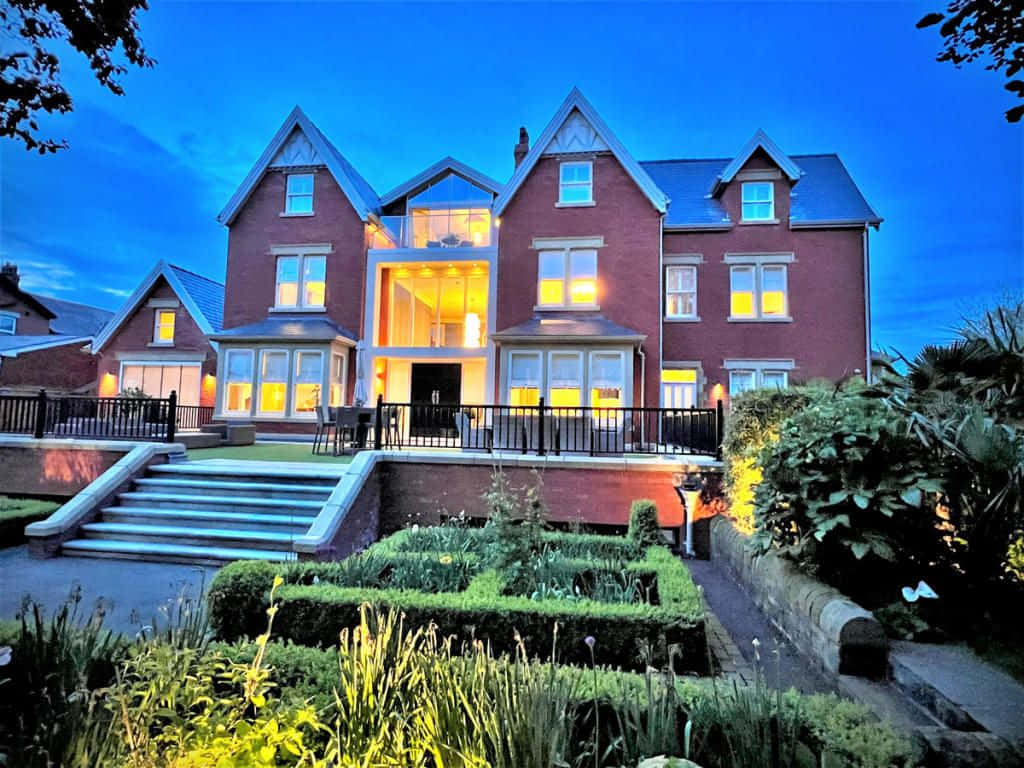 Luxurious Modern Property Overlooking A Scenic Vista Background