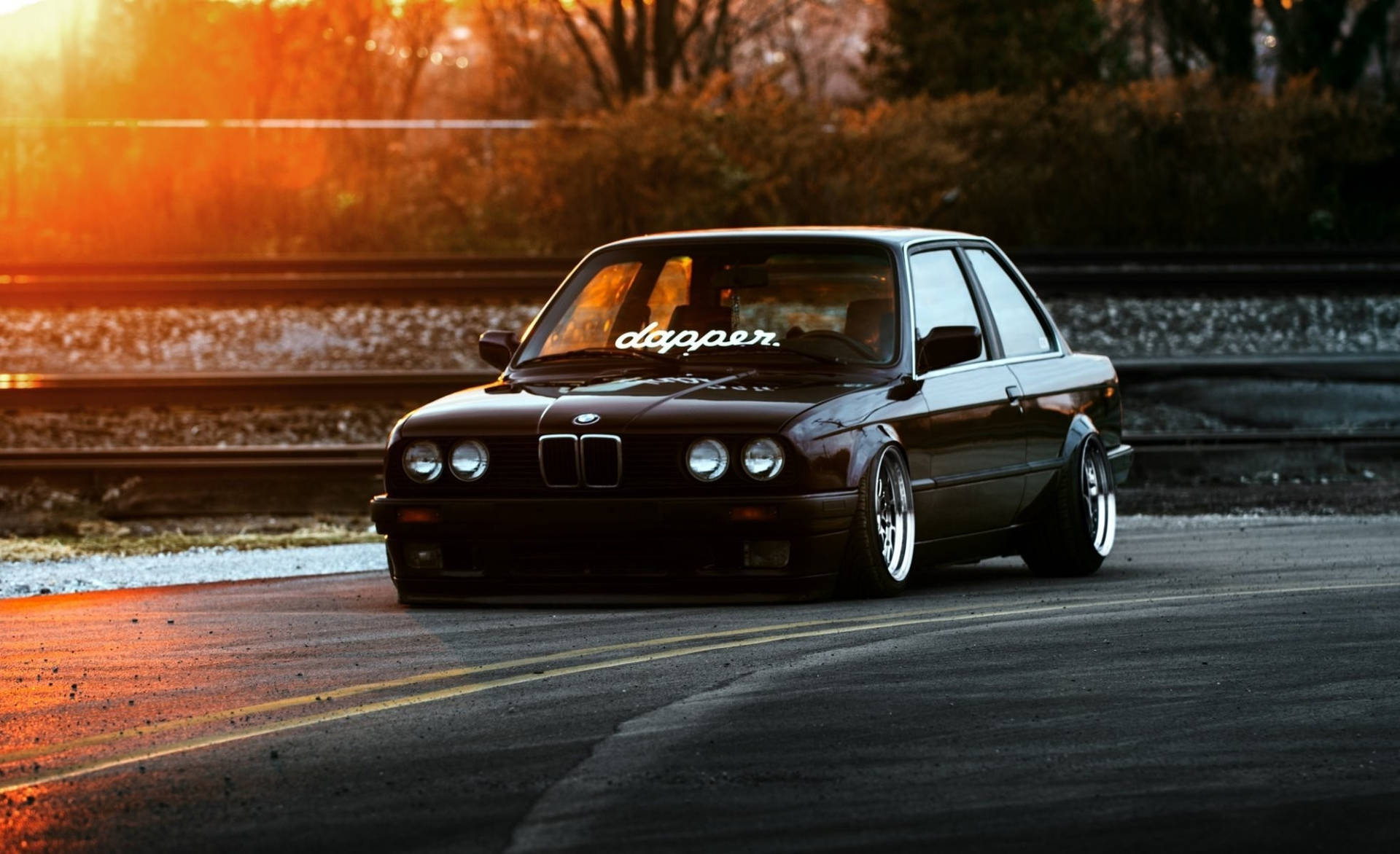 Luxurious Ride: Black Bmw Against A Dramatic Sky Background