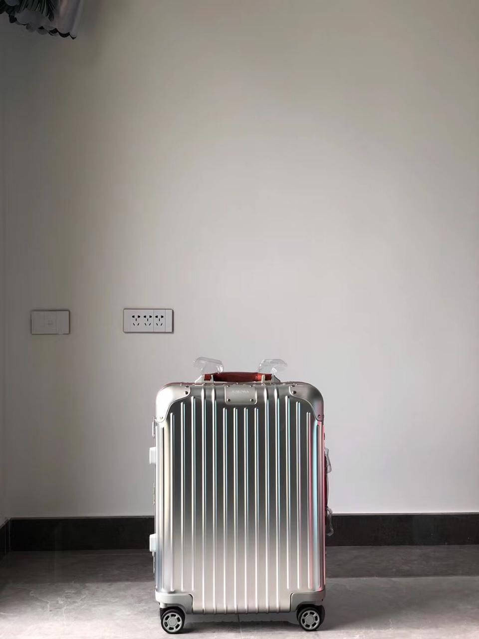 Luxurious Travel With Rimowa Original Cabin S Suitcase Background