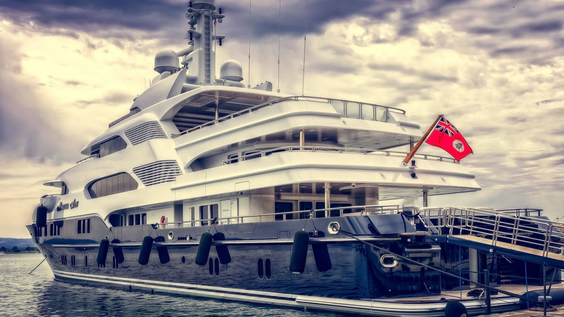 Luxurious Yacht Draped With Red Ensign Background