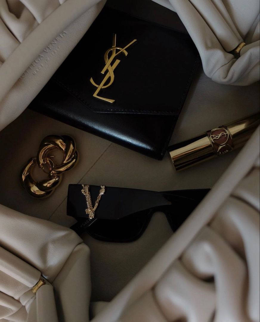 Luxury Items With Ysl Designer Logo Background