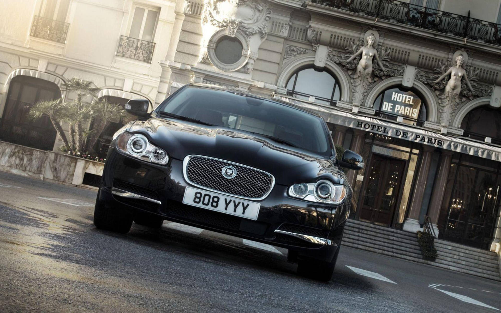 Luxury On Display: Jaguar Car At The Iconic Hotel De Paris Background