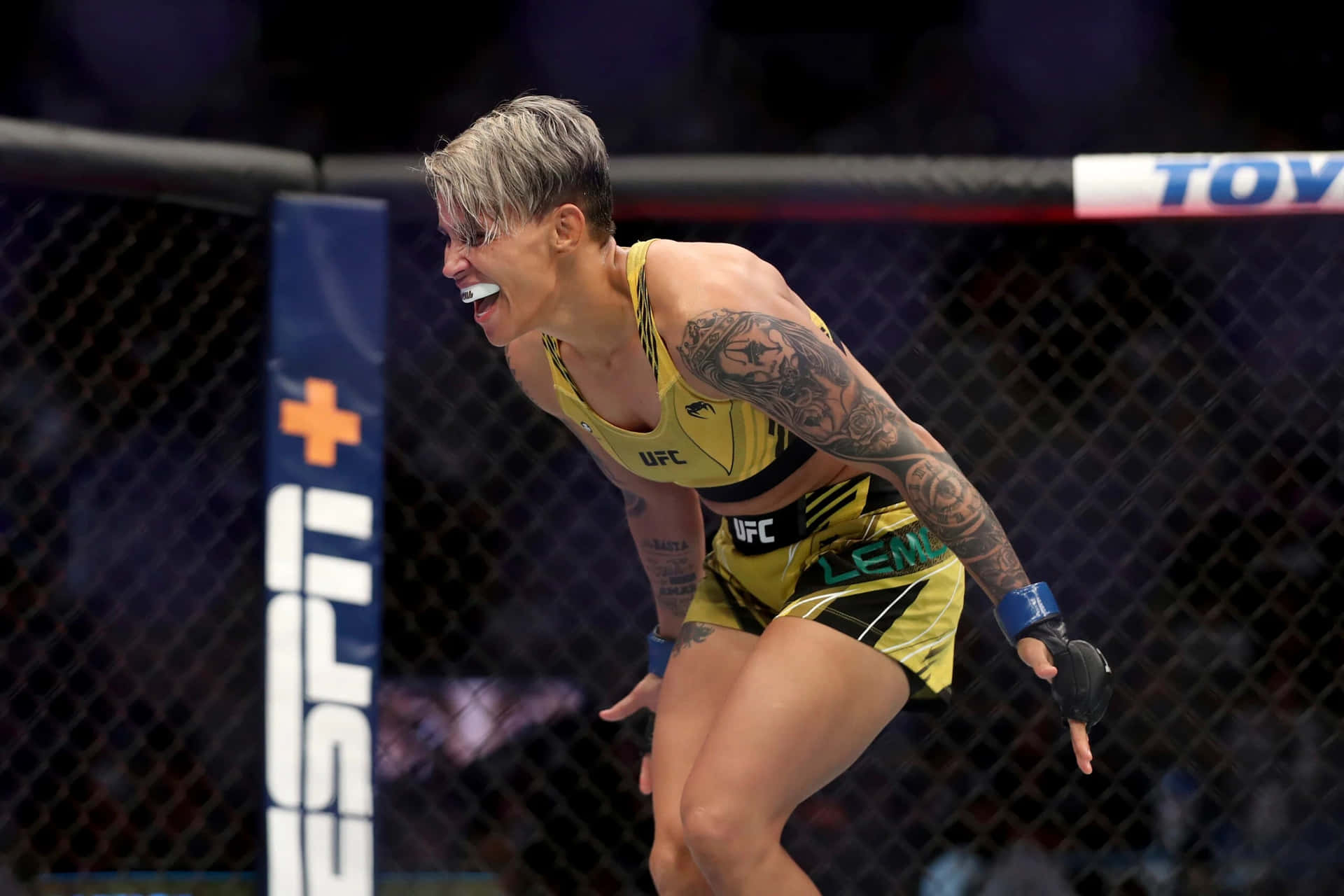 M M A Fighter Celebrationin Octagon Background