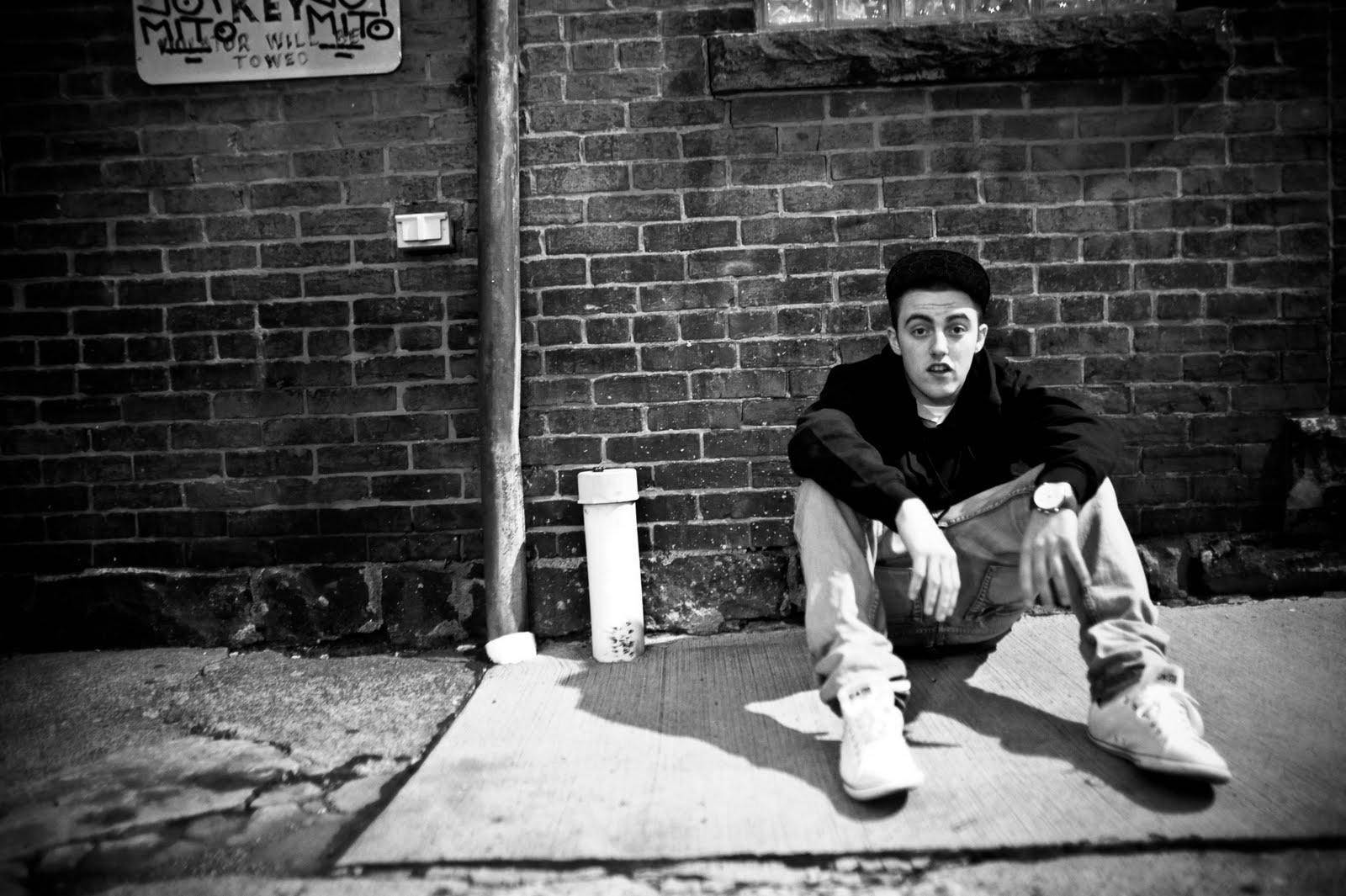 Mac Miller Leaning On Brick Wall
