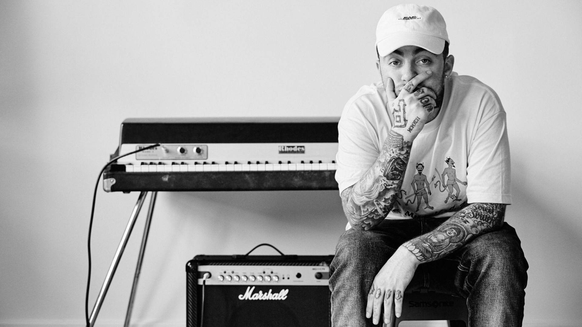 Mac Miller With Synthesizer And Speaker Background