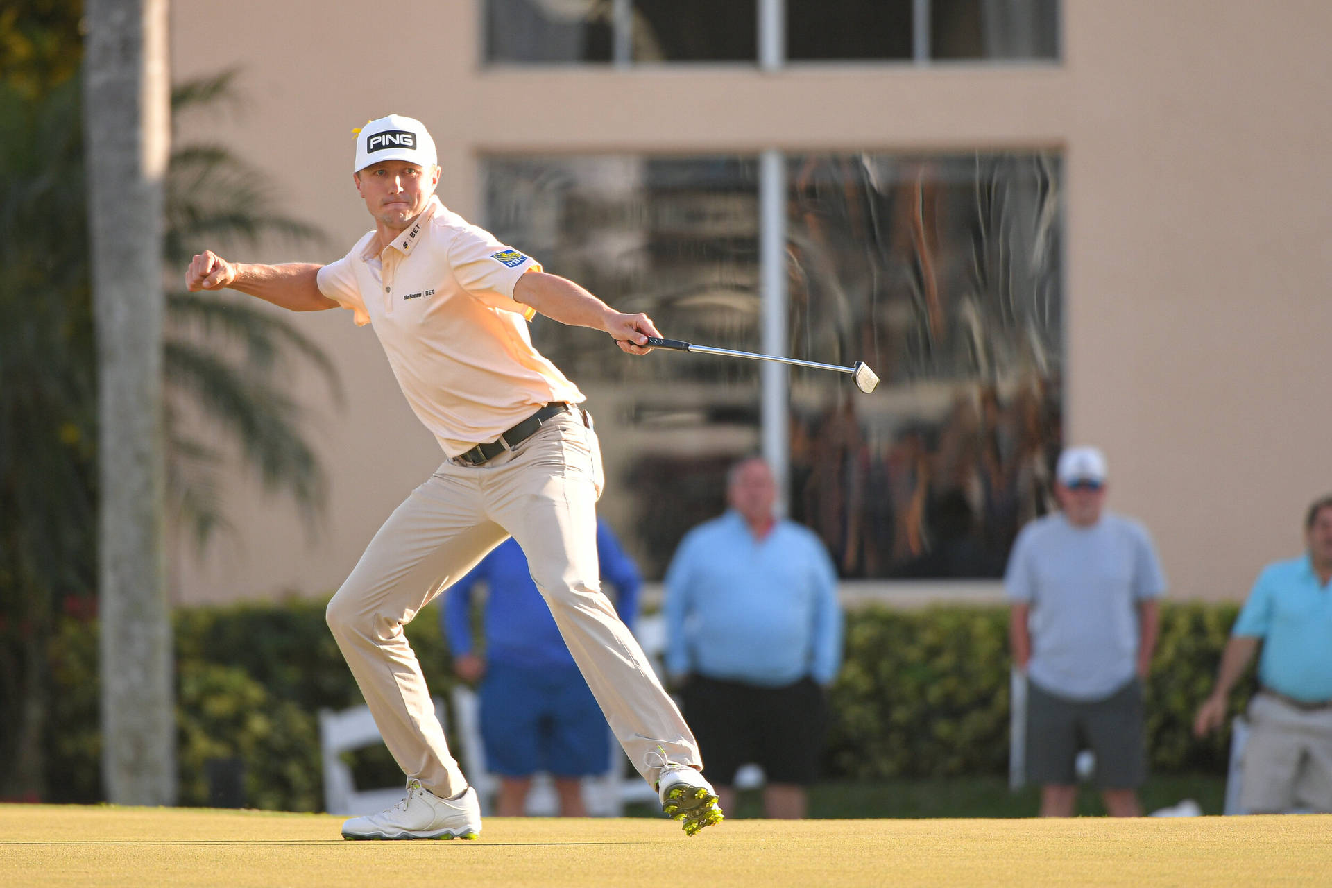 Mackenzie Hughes Holding Golf Club Out Background