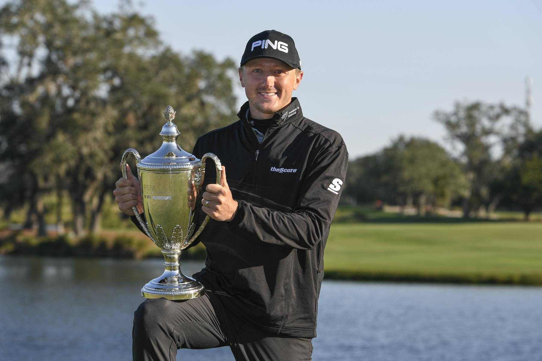 Mackenzie Hughes Holding His Trophy Background