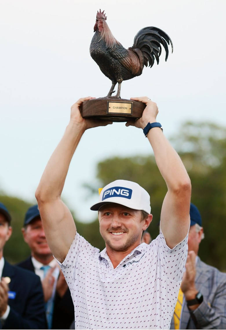 Mackenzie Hughes Holding Trophy Up Background