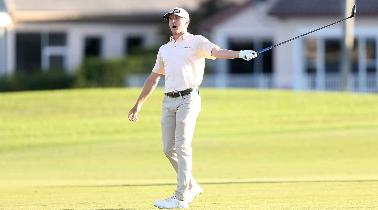 Mackenzie Hughes Pointing With Golf Club Background