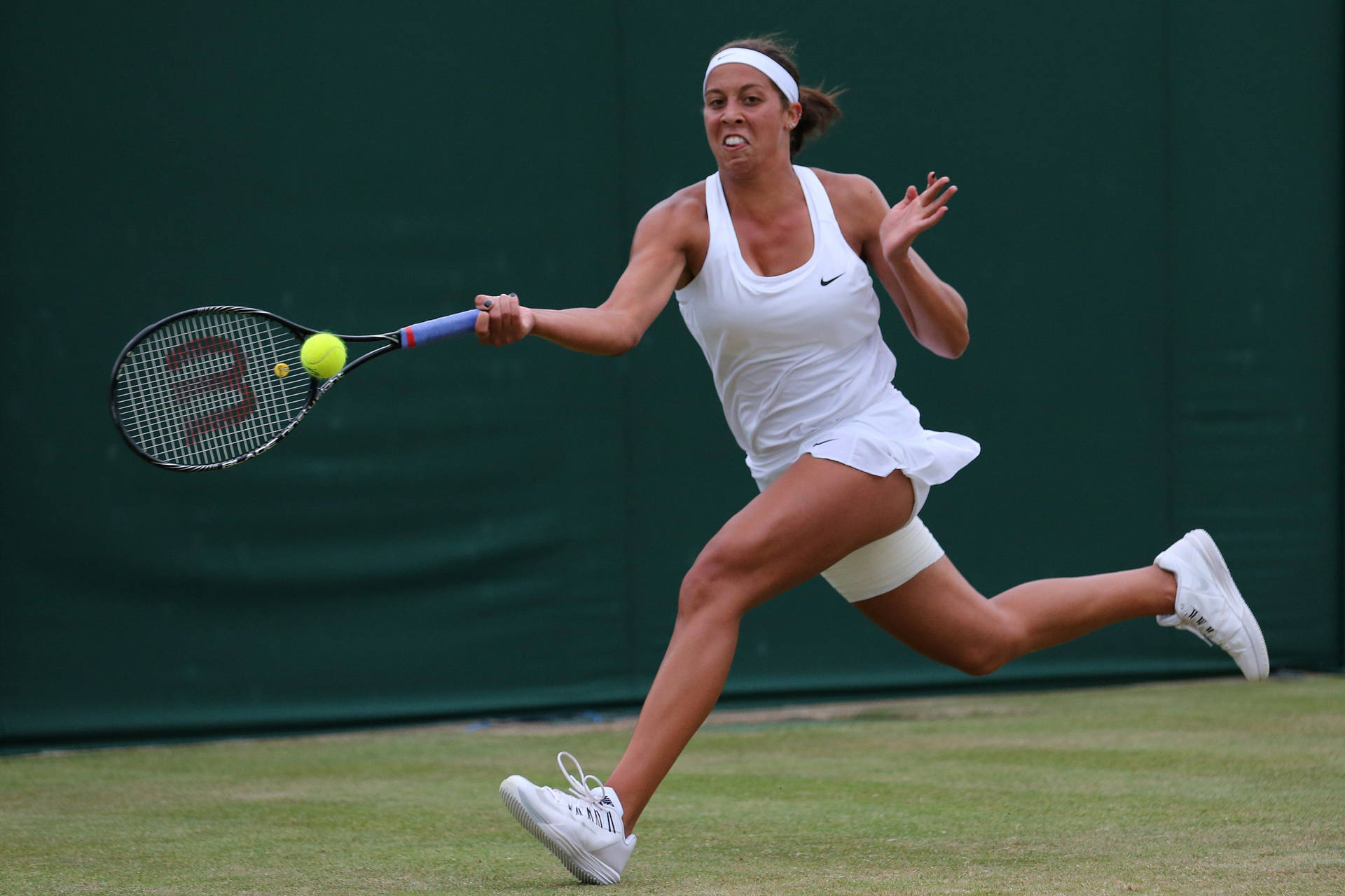 Madison Keys Leaping For Ball Background