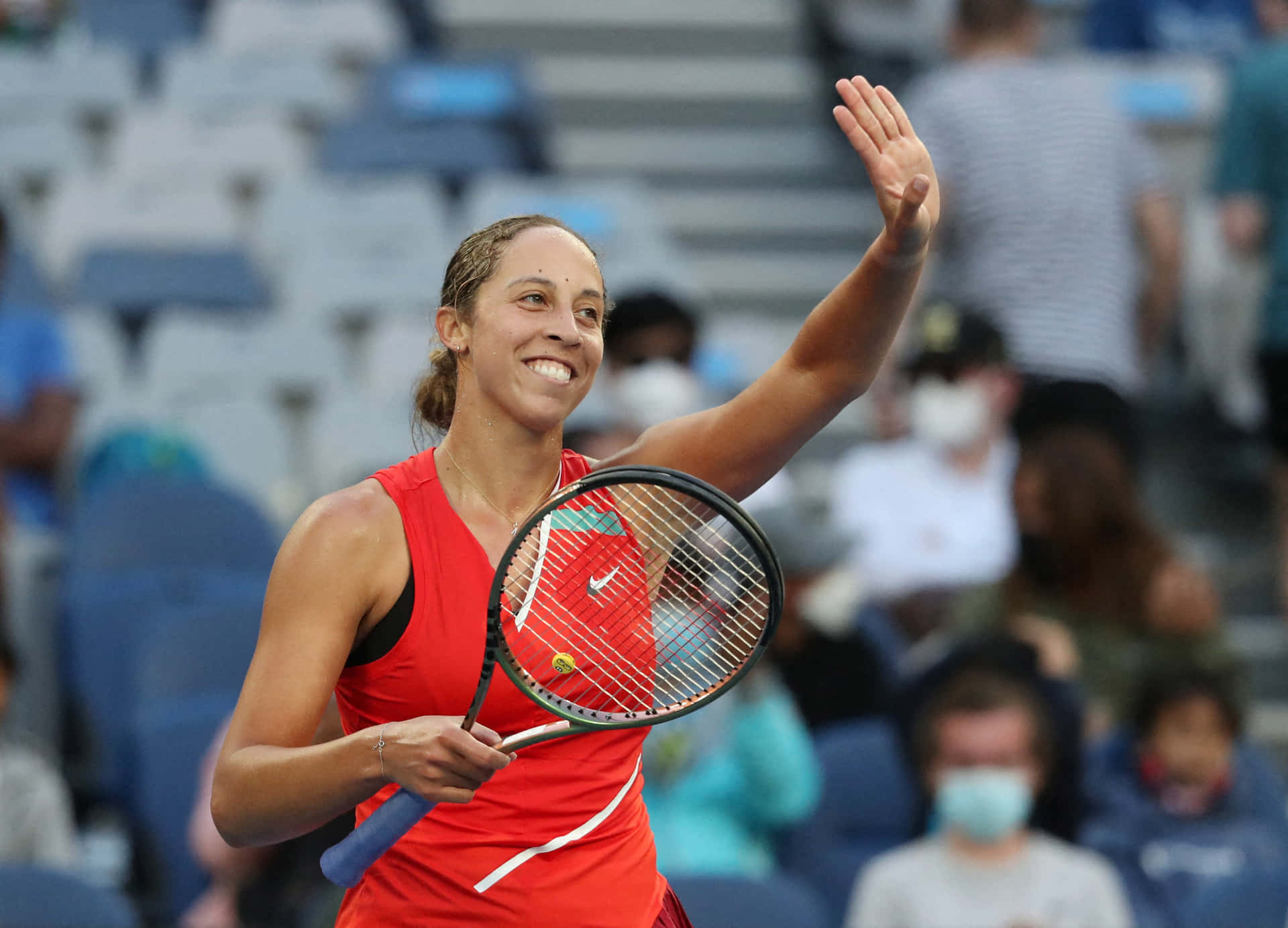 Madison Keys Powerfully Strikes A Tennis Ball Background