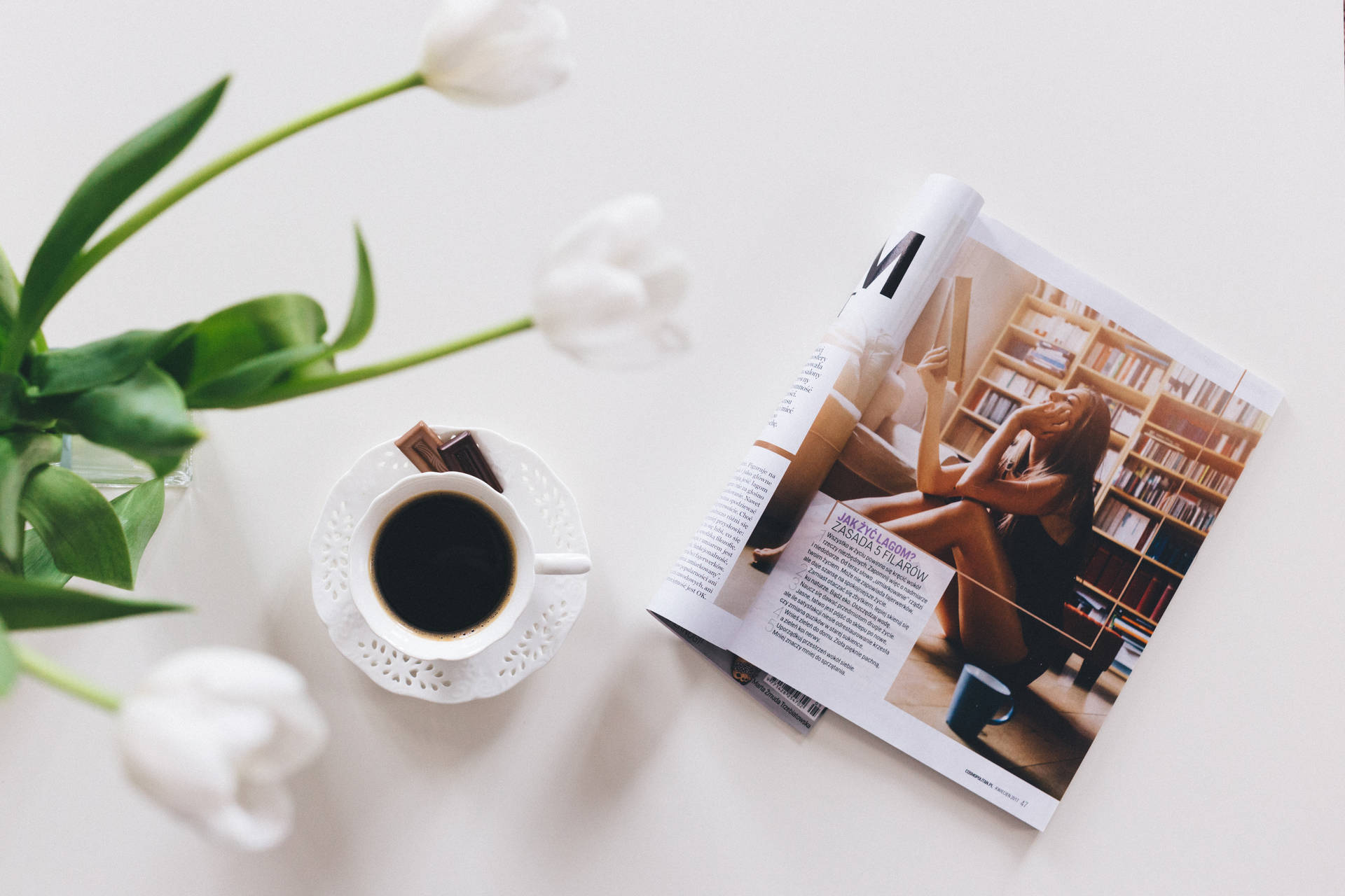Magazine Beside Coffee And Flower Background
