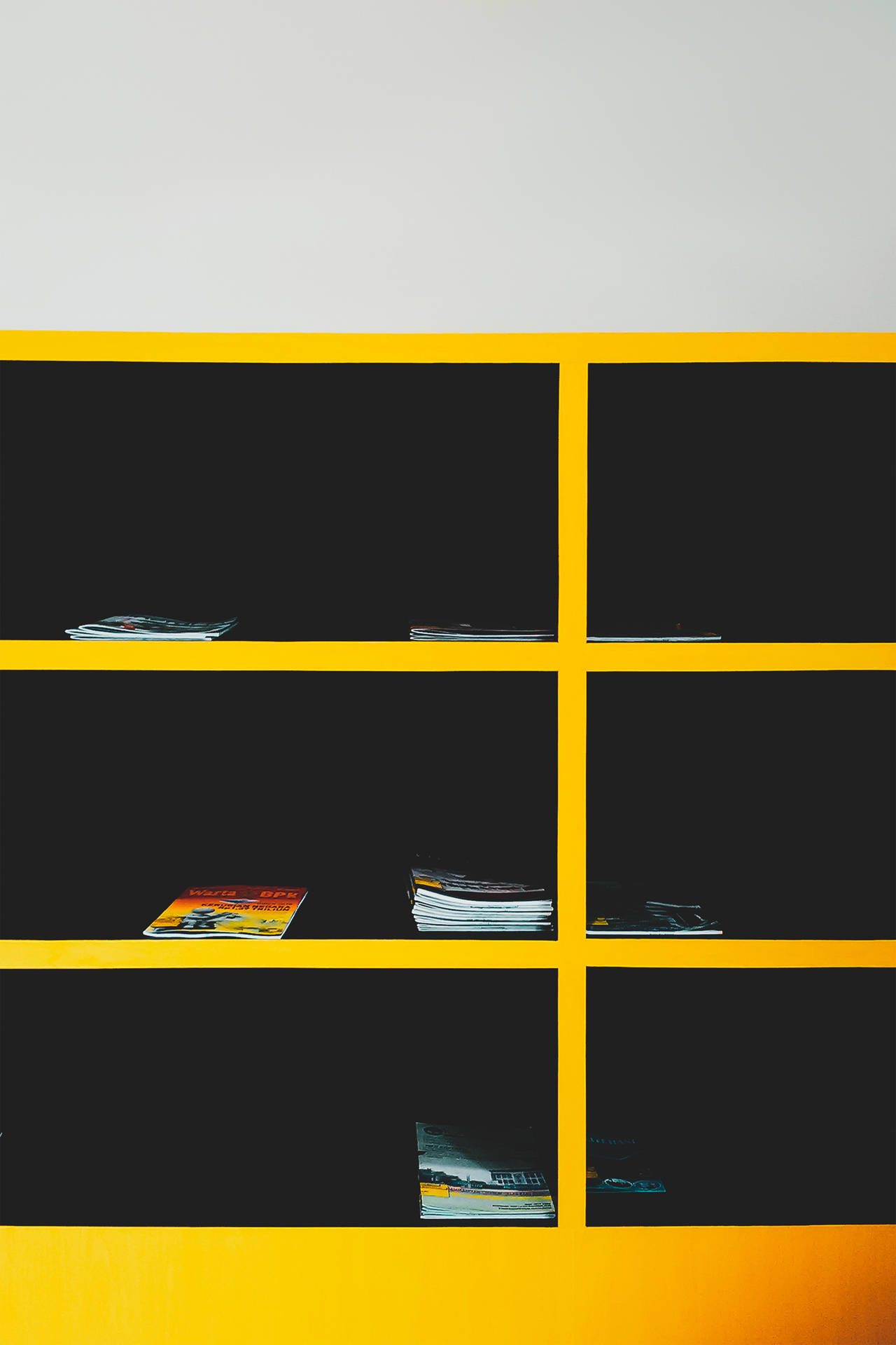 Magazines On Black & Yellow Cabinet Background