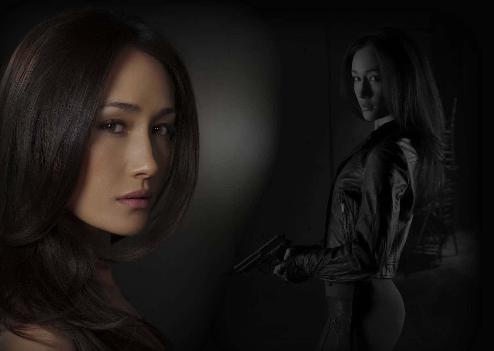 Maggie Q Smiling In A Black Outfit Background