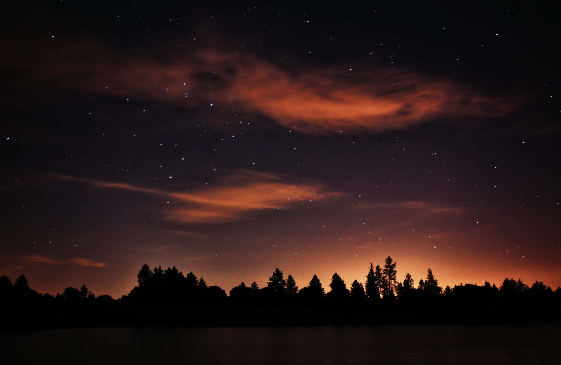 Magical Night Sky With Silhouette Of Trees With Clouds And Stars