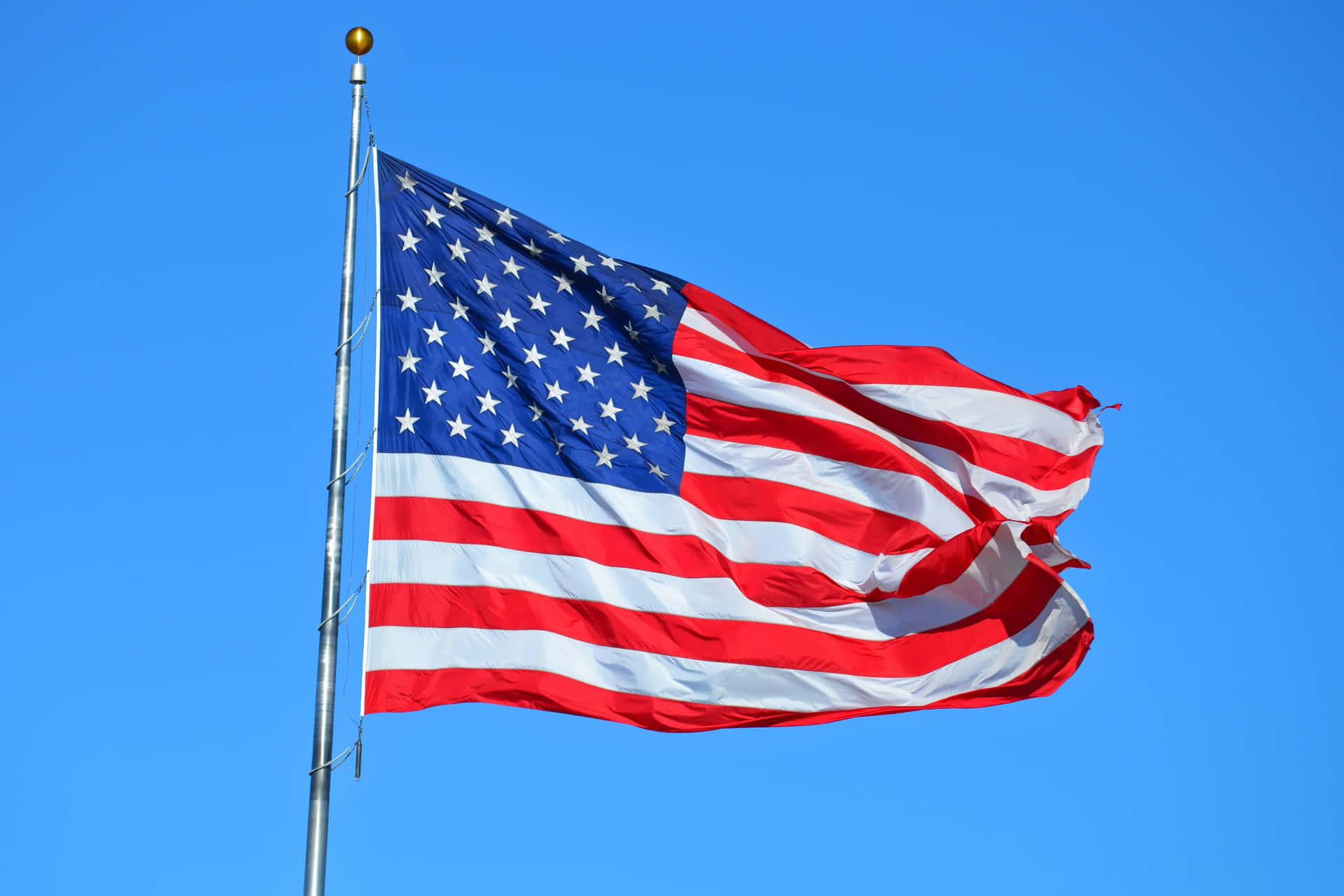 Magnificent U.s. Flag Waving Under The Bright Sunlight Background