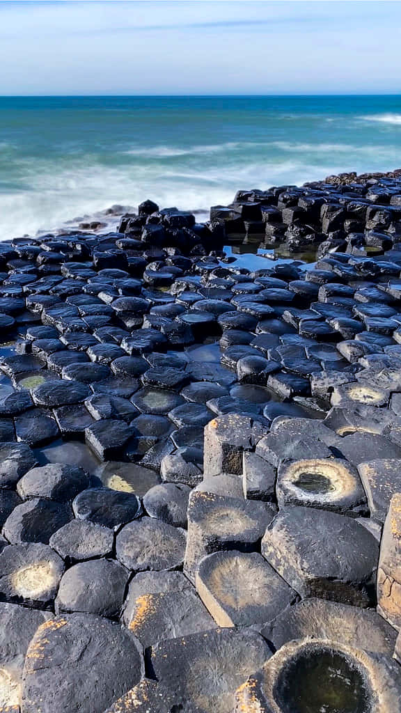 Magnificent View Of Giant's Causeway Against The Blue Ocean