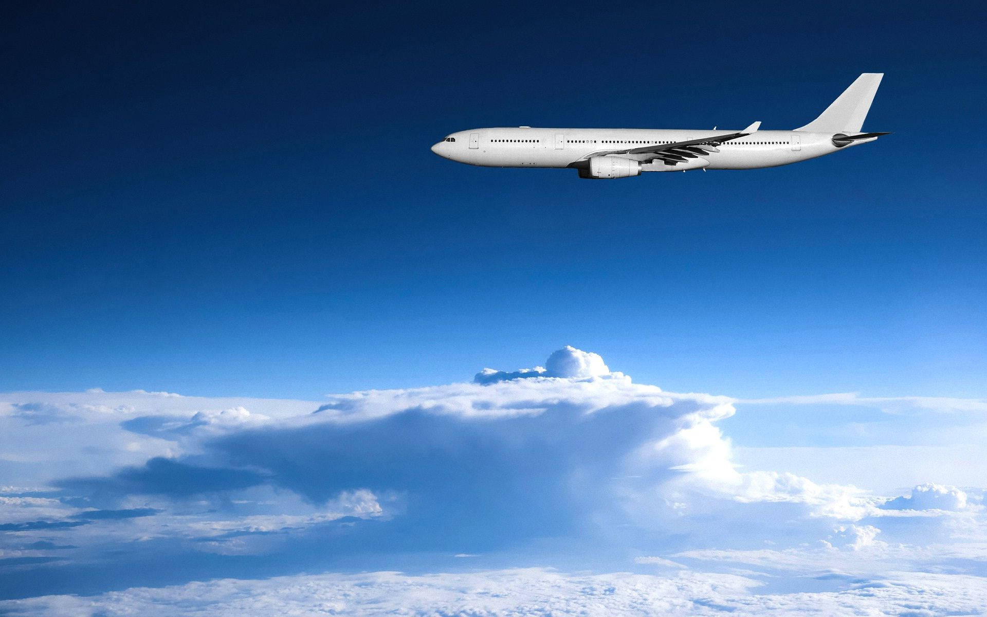 Magnificent White Airplane Soaring Through The Sky Background